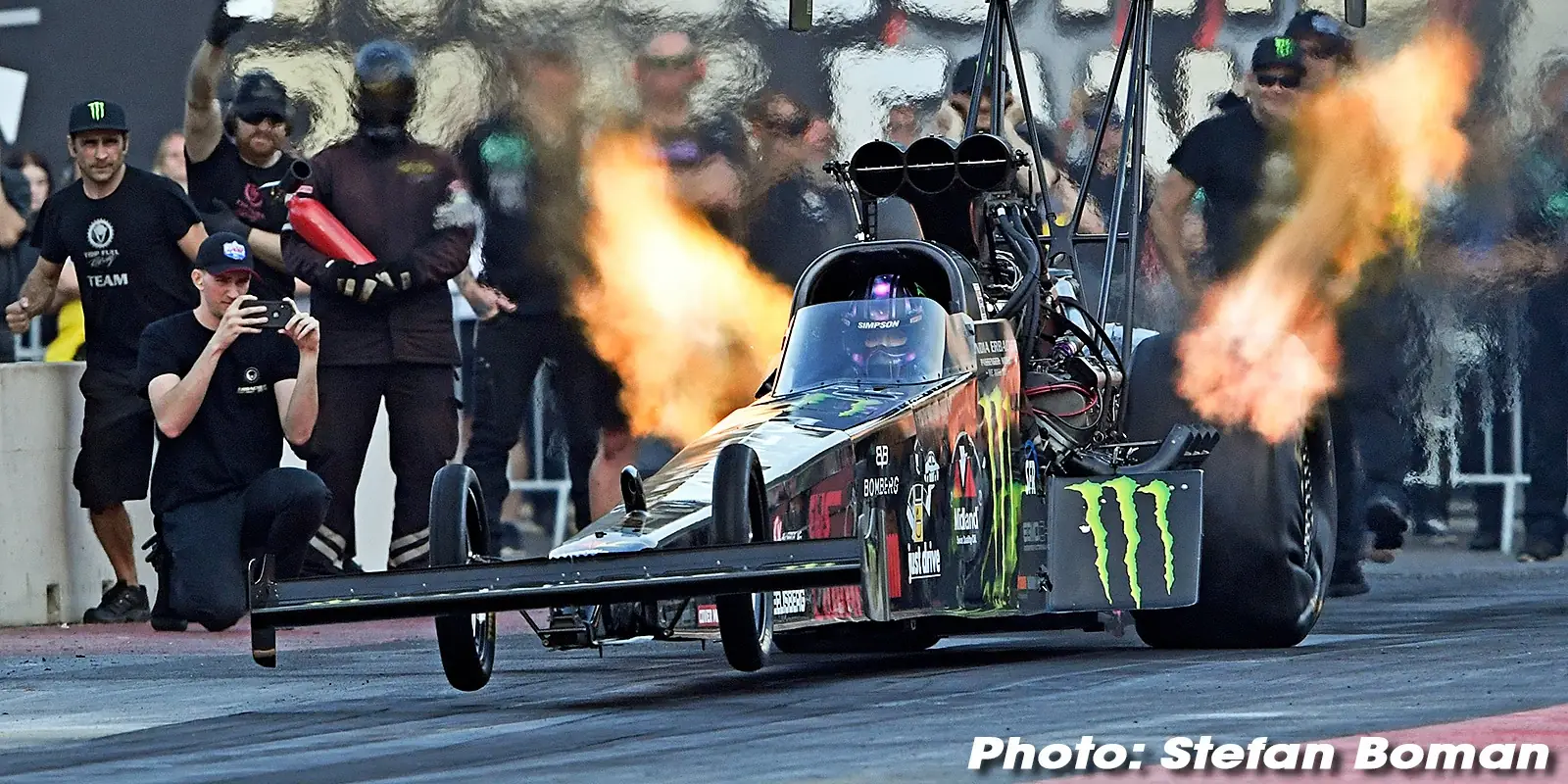 Erbacher Racing's Top Fuel dragster launching with header flames