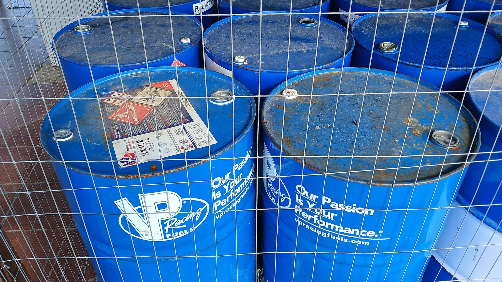 Weathered blue VP Racing fuel drums
